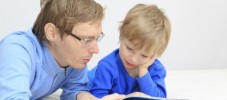 Father and son reading together