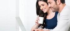 Smiling couple with laptop